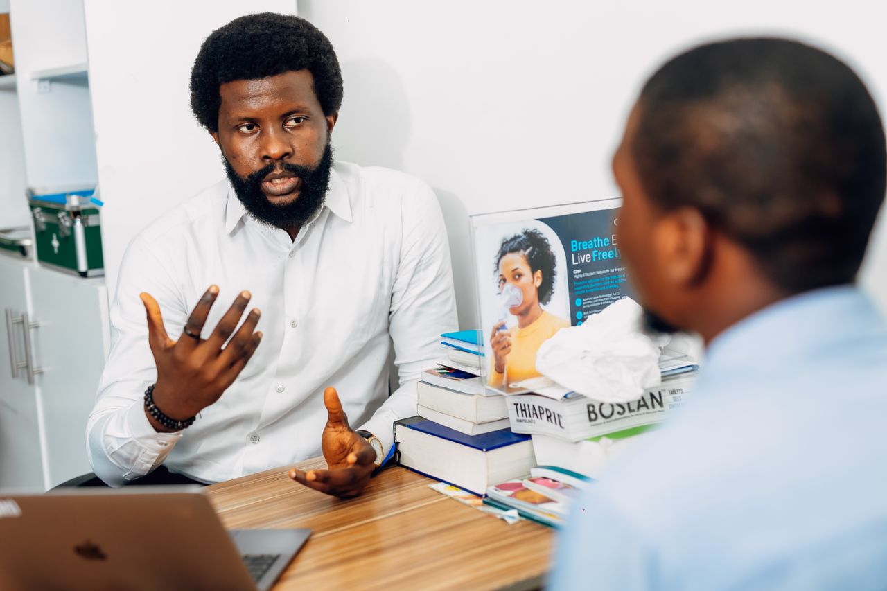 Crafting Captivating Headlines: Your awesome post title goes here A doctor discusses health concerns with a patient at a medical office in Lagos, Nigeria.